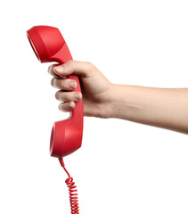 Woman holding red corded telephone handset on white background, closeup. Hotline concept