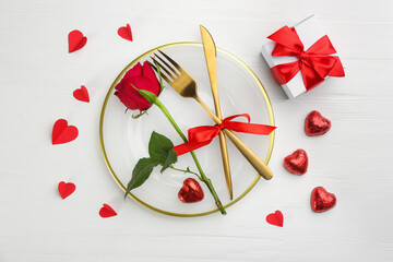 Beautiful table setting for Valentine's Day dinner on white wooden background, flat lay