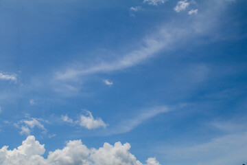 Fototapeta premium Cloudy sky on the horizon above the water. Nature background. Dramatic gray and white clouds in the blue sky.