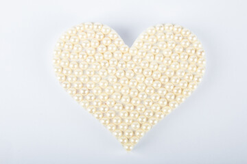 Valentine’s day background with heart of pearls on white background.