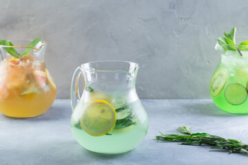  Different color lemonade in glass decanters with fruits and fresh mint