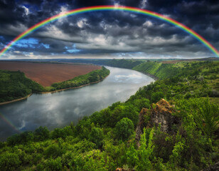 Fototapeta na wymiar colorful rainbow over the river canyon. spring morning