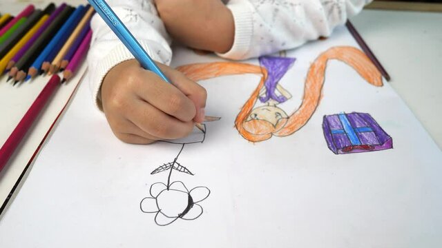 Closed-up children drawing flower.Kid development activities.