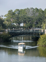Obraz premium A small boat plies the canal in Palmetto Bluff, an exclusive community in South Carolina