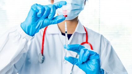 Doctors or scientists are carrying syringes with liquid vaccines for young and old to. prevent...