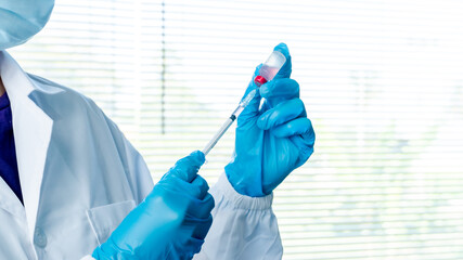 Doctors or scientists are carrying syringes with liquid vaccines for young and old to. prevent...