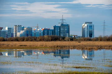 Autumn view on skyscrapers in a new district of Yakutsk City. Skyscrapers with reflection in a lake. - 405008729