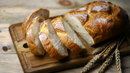 Selective focus. Fresh wheat bread on the board. Bread in slices.