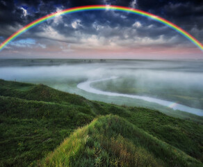 Landscape with a Rainbow on the River in Spring. colorful morning