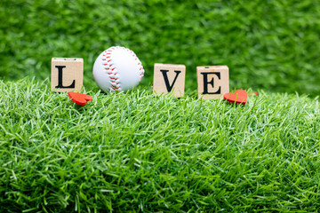 Baseball for Valentine's Day with love on green grass