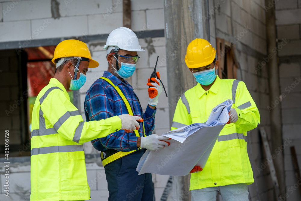 Poster engineer wearing protective mask to protect against covid-19 and checking production process at the 