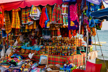 Fototapeta na wymiar Guadelope, France - February 10, 2020: Typical tourist market in Guadeloupe selling tradicional beverages, spices and other itens.