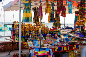 Typical tourist market in Guadeloupe selling traditional beverages, spices and other itens. - 405016783