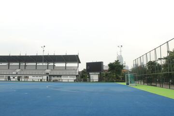 The hockey court with the blue floor looks very quiet in the afternoon