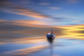 a boat at the sunset on the beach