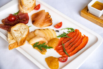 assorted salted fish on white plate. snacks on holiday table.
