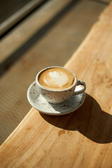  hot latte art coffee on wooden