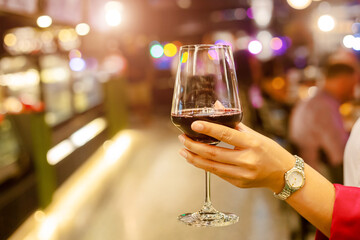 woman holding wine glass in restaurant
