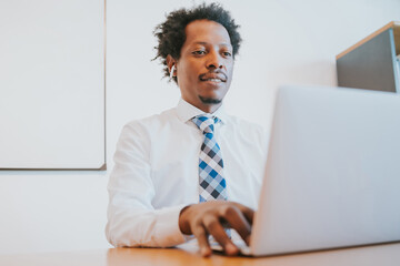 Businessman working with laptop at office.