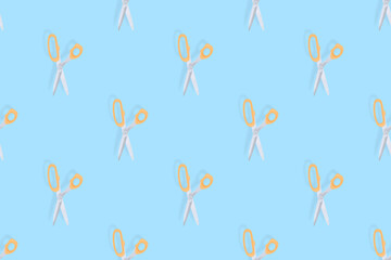 Scissors seamless pattern. Barber scissors against blue background backdrop.