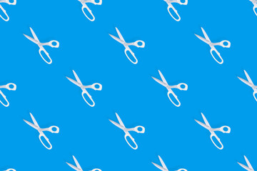 Scissors seamless pattern. Barber scissors against blue background backdrop.