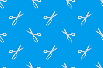 Scissors seamless pattern. Barber scissors against blue background backdrop.