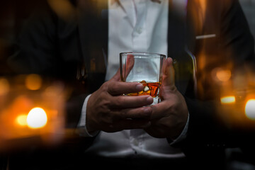 Closeup businessmen holding a glass of whiskey