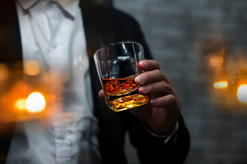 Closeup businessmen holding a glass of whiskey