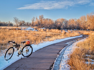touring bicycle in late fall or winter scenery - one of numerous bike trails in Fort Collins, northern Colorado, recreation and commuting concept