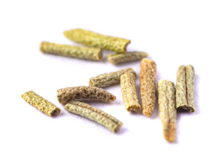 Pile of dried rosemary leaves isolated on white background. Macro photo