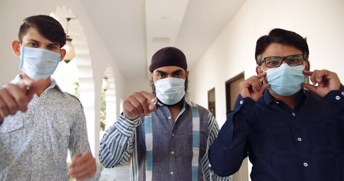 Group Of Three Adult Men Wearing Face Masks As They Look At Camera And Make Hand Gesture Signs- Pointing Finger And Requesting Demanding Arguing And Pleading People To Wear Protective Mask