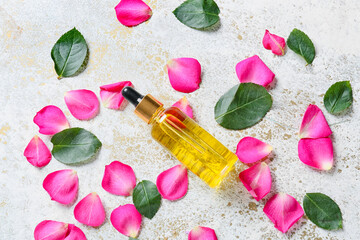 Obraz na płótnie Canvas Bottle with floral essential oil on light background