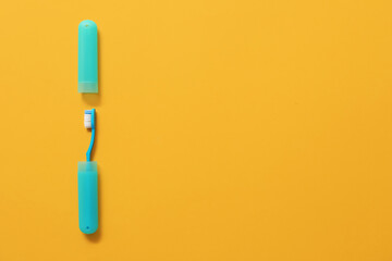 Toothbrush and case on color background