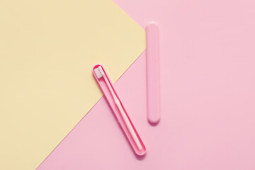 Toothbrush and case on color background