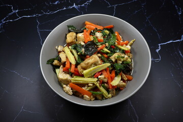 Fried and stirred mixed vegetable, chilly and tofu serving on the plate. Famous vegetarian menu in Asia restaurant. 