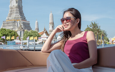 Asian woman sitting on boat with beautiful landscape
