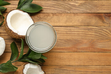 Glass of fresh coconut water on wooden background