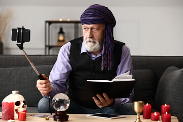 Male fortune teller recording video for blog