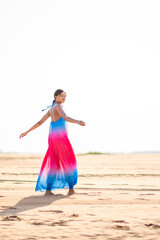 beautiful young african woman wearing a colorful dress, having fun outdoor, summer holiday concept