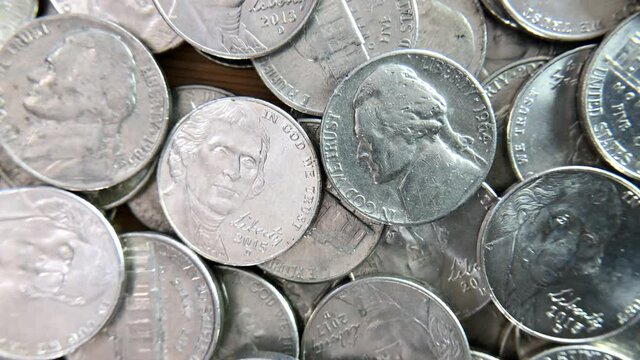 4K HD video zooming in on two coins in the middle of a pile of Nickels. The U.S.  five cent coin, called a nickel, is composed of 75 percent copper and 25 nickel&nbsp;nickel
