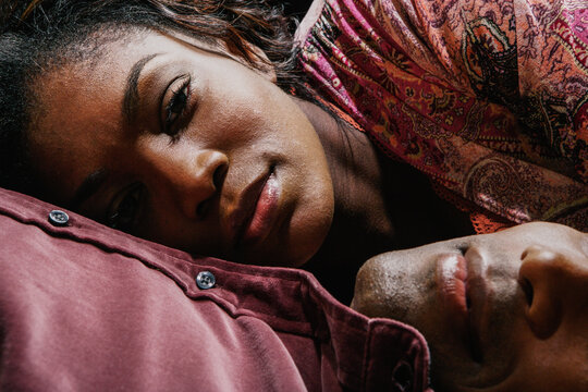 Close up of woman with head on man's chest