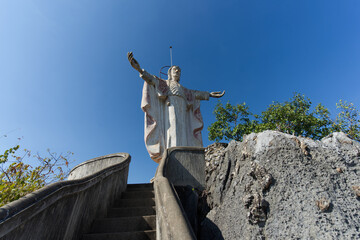 big stone statue of jesus On the mountain in Ratchaburi Province near Bangkok, Thailand