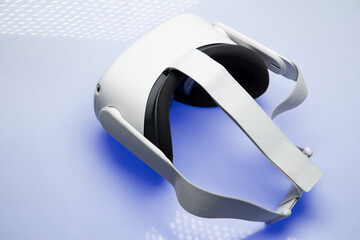 Fototapeta premium White new generation VR headset isolated on white background with blue sparkling futuristic lights. Virtual reality headset 