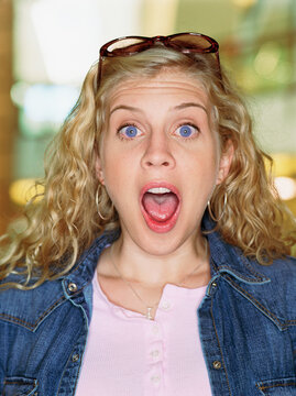 Portrait of woman screaming with mouth wide open