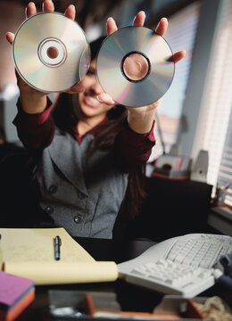 Businesswoman holding compact discs