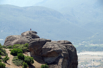 couple standing on a rock in Meteora Greece
