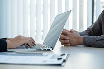 Business people hold a resume and talk to job applicants for job interviews about careers and Her...