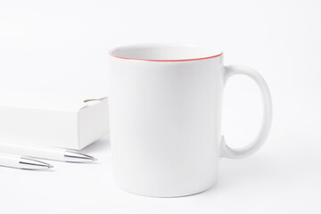 Minimalism concept, coffee cup and pencils on white office desk