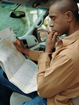 Man reading map in car