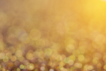 blurred sparkling gold color glitter light as abstract festive background for website banner and card decoration design